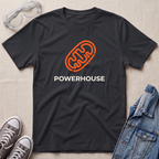 A black t-shirt with an orange mitochondrial outline and the word 'POWERHOUSE' in white, styled in a flat lay with jeans, sneakers, and safety goggles on a beige textured background.