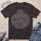 A dark chocolate brown botanical t-shirt featuring an intricate tree root illustration with the pun “I’m Rooting For You” in bold vintage-style lettering.
