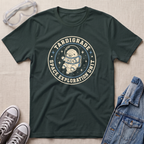 A forest green graphic t-shirt featuring a retro circular design with an astronaut and the text 'TARDIGRADE SPACE EXPLORATION UNIT'. The shirt is styled in a flat-lay arrangement on a beige textured background, accompanied by clear safety goggles, gray sneakers, and a blue denim jacket.