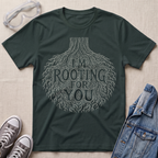 A dark forest green botanical t-shirt featuring an intricate tree root illustration with the pun “I’m Rooting For You” in bold vintage-style lettering.