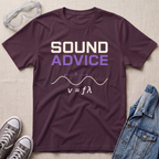 A maroon graphic t-shirt laid flat on a light beige textured background, styled with clear safety goggles, gray sneakers, and a blue denim jacket. The t-shirt features the text 'SOUND ADVICE' in white and purple, above a white sound wave diagram and the equation v = fϗϙ.