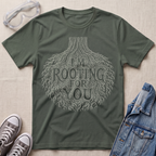 A military green botanical t-shirt featuring an intricate tree root illustration with the pun “I’m Rooting For You” in bold vintage-style lettering.