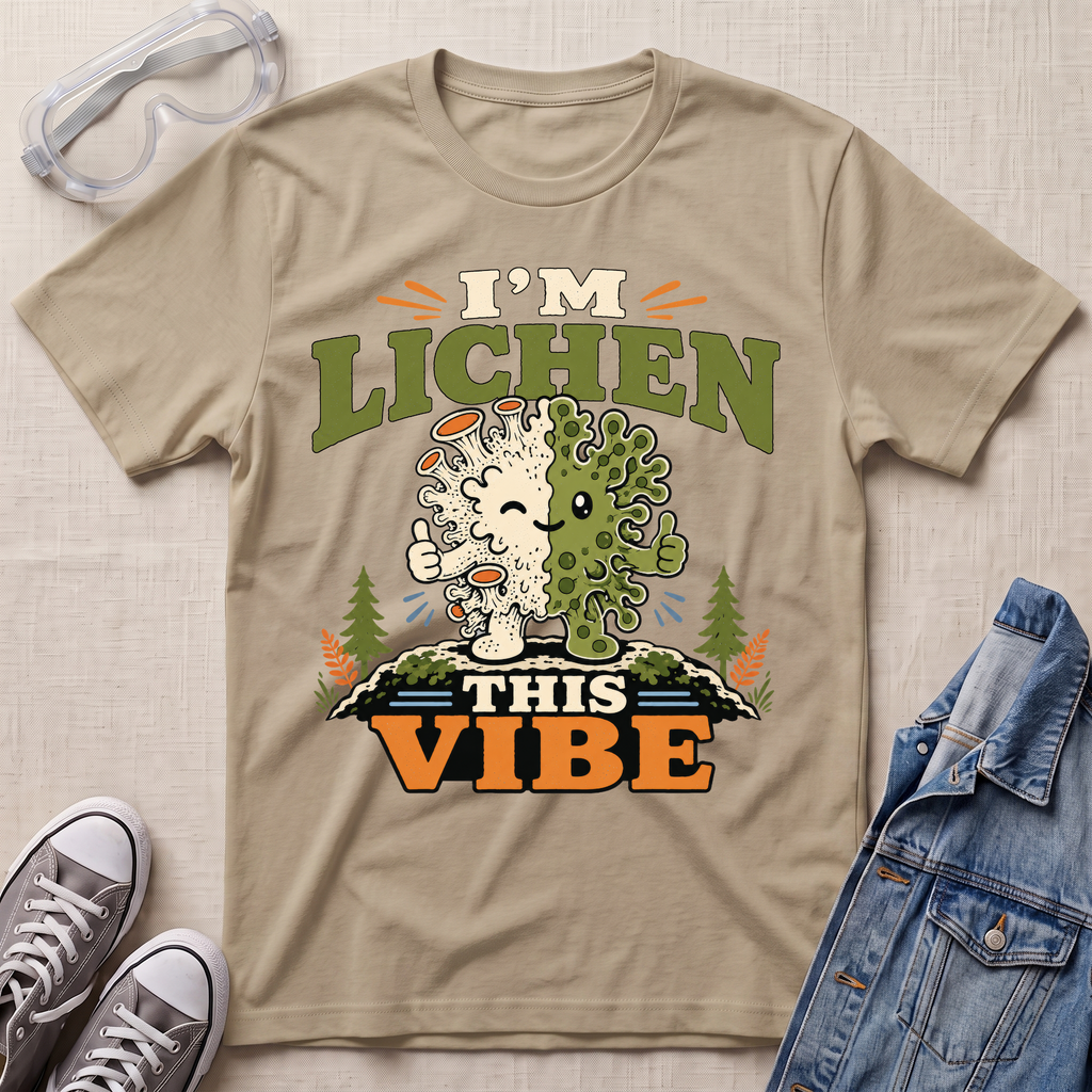 A beige science t-shirt featuring a cute lichen character with the pun “I’m Lichen This Vibe,” surrounded by retro botanical and nature-inspired accents.