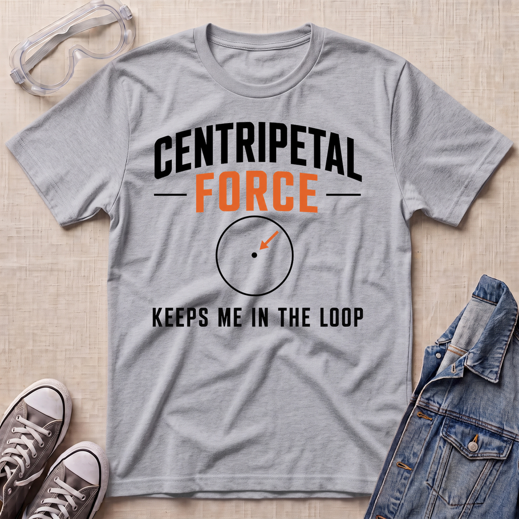 A heather gray graphic t-shirt laid flat on a beige textured surface, styled with safety goggles, gray sneakers, and a denim jacket. The t-shirt features the text 'CENTRIPETAL FORCE' in black and orange, with an arrow graphic, and 'KEEPS ME IN THE LOOP' underneath.