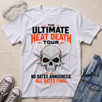 A white graphic t-shirt laid flat on a light beige fabric background, styled with clear safety goggles, gray sneakers, and a blue denim jacket. The t-shirt features a skull graphic with glowing red eyes and bold text reading 'THE ULTIMATE HEAT DEATH TOUR' and 'NO DATES ANNOUNCED.